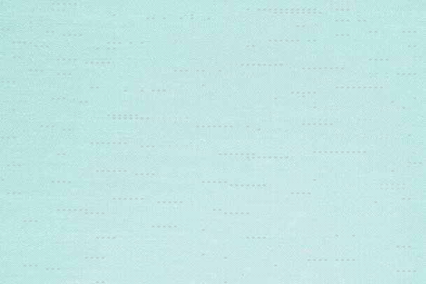 istock Authentic fine Thai silk fabric textile detailed texture background in light green blue color 1318550501