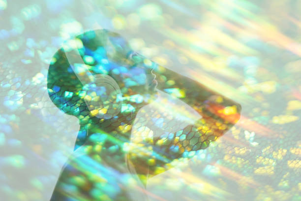 Double exposure shape. Music inspiration. Sound relaxation. Silhouette portrait of calm girl enjoying listening to audio in headphones in blur colorful iridescent green orange scale bokeh light rays.