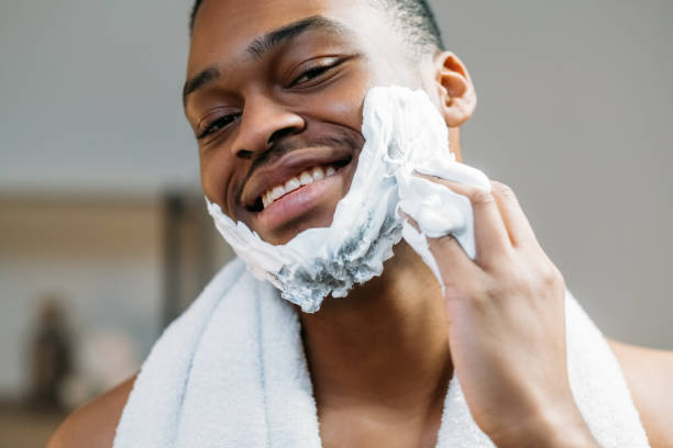 istock man grooming applying shaving foam dark face skin 1318554024