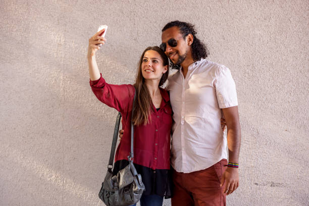 istock Mixed Race Heterosexual Couple Taking A Selfie Using Smart Phone 1318555390