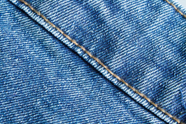 istock Blue jeans close up. Light blue thick fabric for trousers. 1318557968