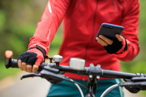 istock Cyclist use smartphone when riding mountain bike on forest trail 1318561324