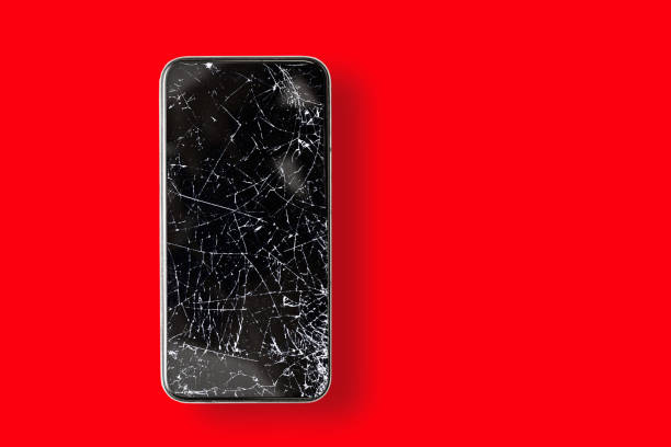 istock Black broken touch screen phone on a red background. Phone with cracked screen 1318562192