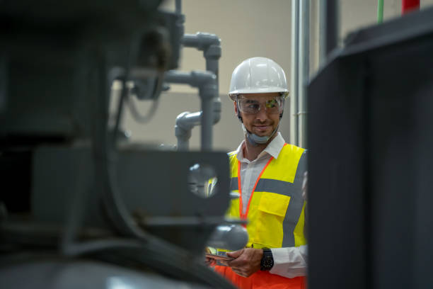 istock Portrait of electrician engineer use tablet computer taking notes at control room. 1318562939