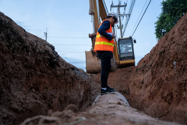 istock Engineer wear safety uniform examining excavation concrete Drainage Pipe at construction site. 1318563005