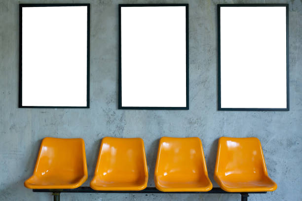 istock Yellow plastic chairs at the bus stop  on concrete wall background, copy space for text. 1318563062