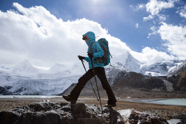 istock Woman backpacker hiking in winter high altitude mountains 1318563314