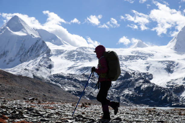 istock Woman backpacker hiking in winter high altitude mountains 1318563847