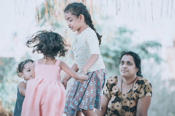 istock mother playing with her kids in front of home 1318568746