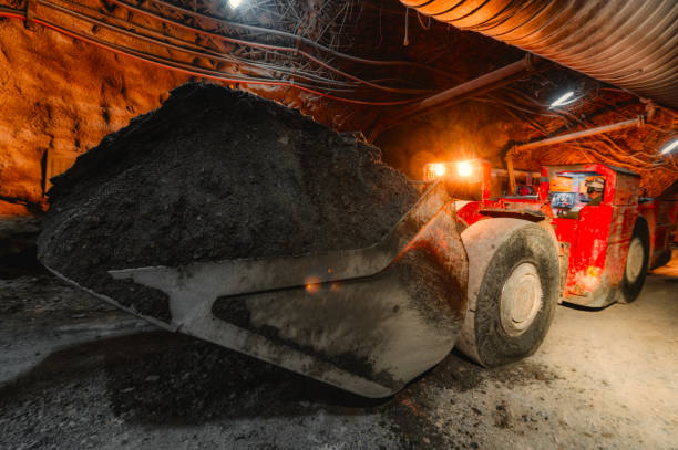 istock An underground loading machine carries a full bucket of ore. Special low-profile equipment for underground work 1318571335