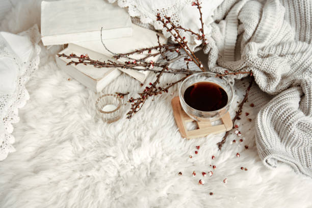 istock Spring composition with a cup of tea, flowering branches and a knitted element. 1318573032