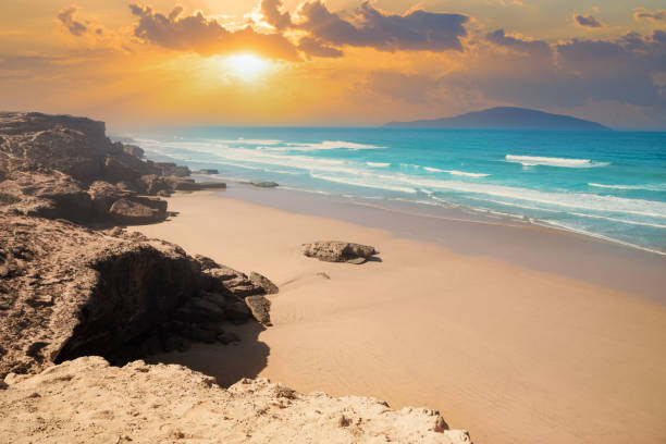 Moroccan beach on the Atlantic coast Beautiful sunset illuminating the beach and sand on the Atlantic ocean coast in Morocco sunset agadir marocco stock pictures, royalty-free photos & images