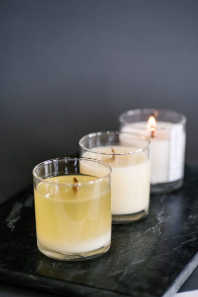 istock Three candles stand on the table on a gray background. 1318575318