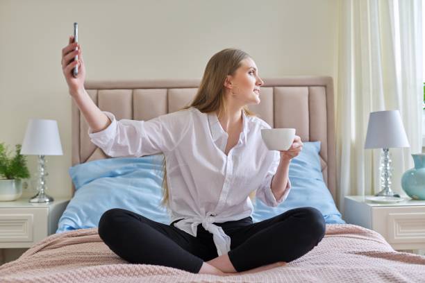 istock Happy talking young woman using video communication on smartphone 1318577638