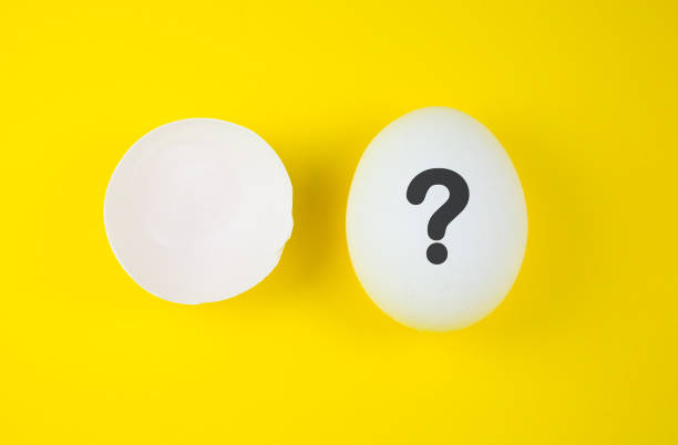 istock White egg with question mark and eggshell on the yellow background. Pregnancy and baby concept. Who is? Copy space. Minimalism, original and creative photo. Beautiful wallpaper. Easter holidays. 1318579277