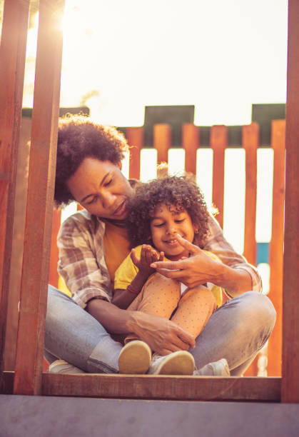 istock Mother and daughter on playground. 1318579604