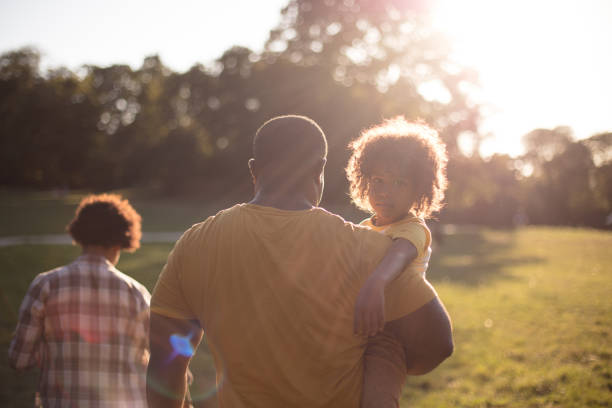 African American family in nature.  Walk with mom and dad. African American family in nature. group of people men mature adult serious stock pictures, royalty-free photos & images