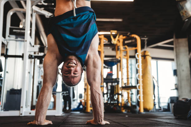 istock Young handsome man doing exercises in gym 1318583511