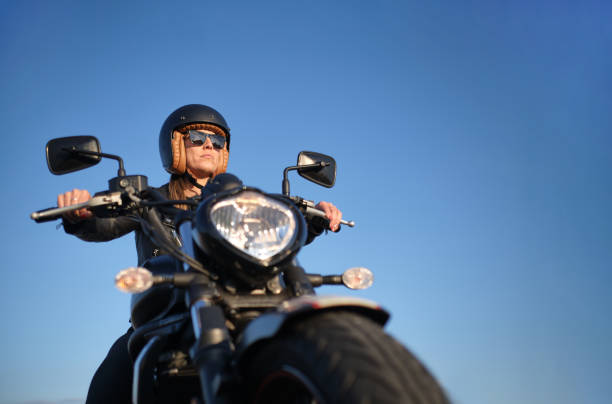 istock woman riding a motorcycle on a sunny day 1318583533