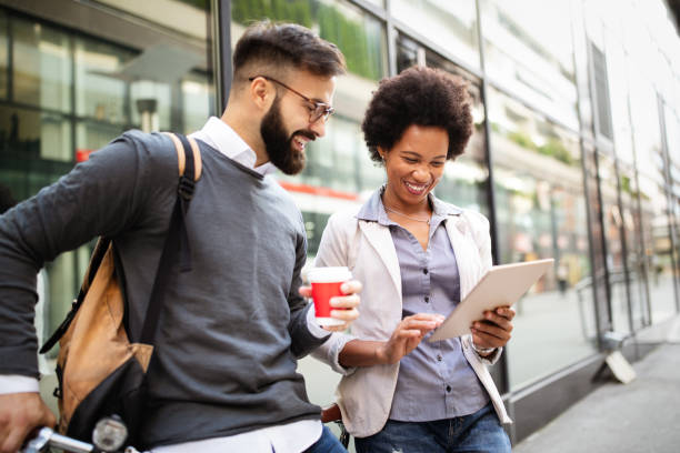 istock Business people on coffee break using digital tablet outdoor 1318584886