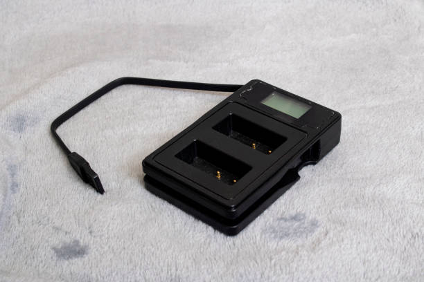 istock Charger for two batteries on gray background 1318585641