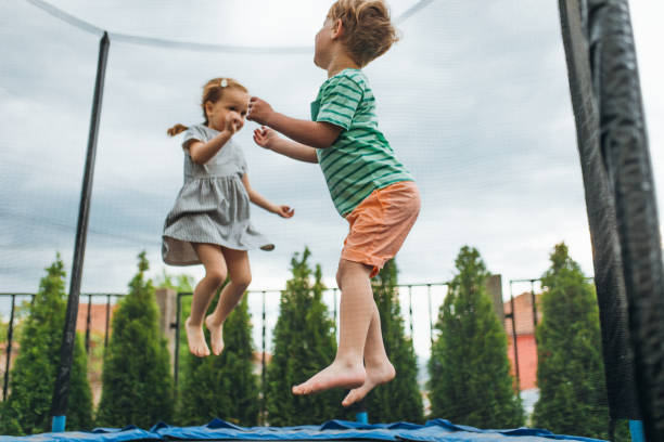 istock Brother and Sister have fun on the trampoline 1318587218