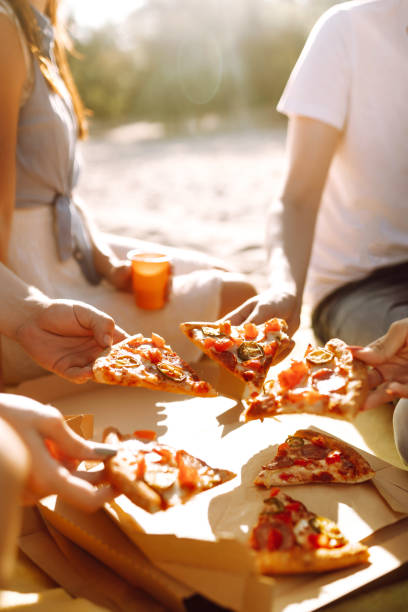 istock Hands taking slices of pizza close view. 1318588032
