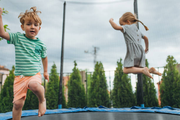istock Brother and Sister have fun on the trampoline 1318588084