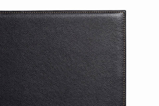 istock Black fine texture of genuine leather. Close-up edge. White threds 1318590410
