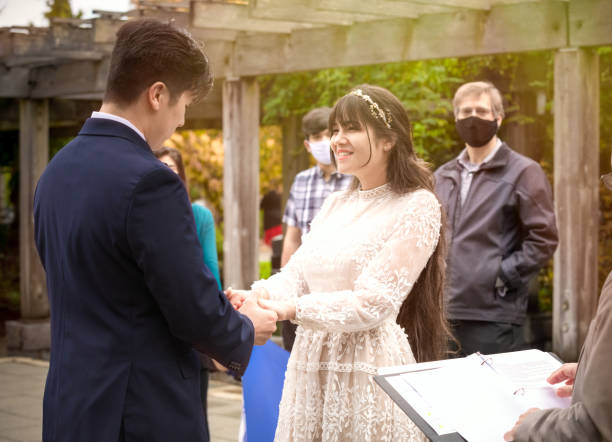 istock Bride groom holding hands during outdoor wedding ceremony 1318594259