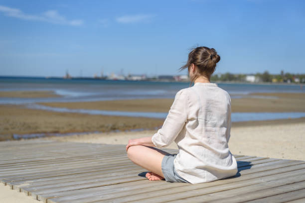 istock Woman doing yoga poses on beach 1318594401