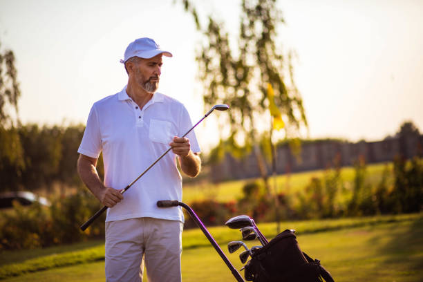 istock Senior golfer standing on court. 1318594462
