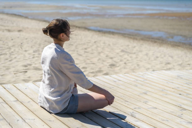 istock Woman doing yoga poses on beach 1318595252