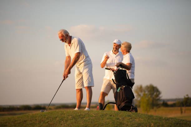 istock Three senior golfer on filed. Man playing golf. Focus is on man.  His support is always there. 1318595296