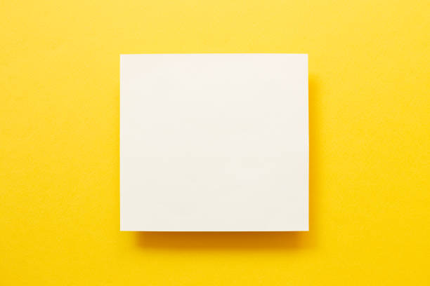istock White memo pad on yellow background. top view, copy space 1318597233