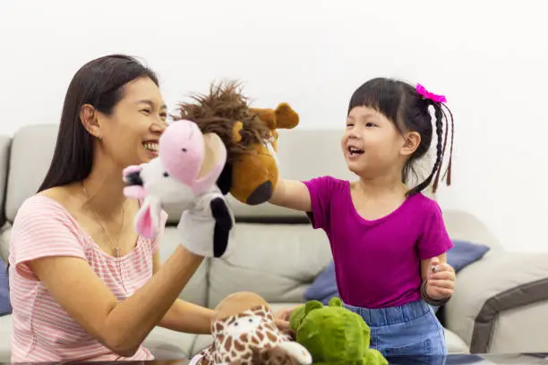 Photo of Happy loving mommy enjoying funny childish activity with daughter