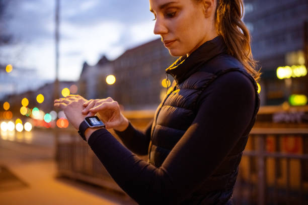 istock Woman checking her smartwatch after exercising outside in evening 1318598095