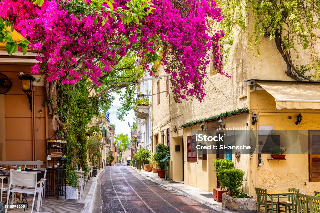 Beautiful view to the little streets of the old town Plaka of Athens, Greece Beautiful view to the little streets of the old town Plaka of Athens, Greece with colorful houses and blooming bougainvillea flowers Athens - Greece Stock Photo