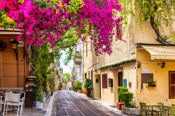 Beautiful view to the little streets of the old town Plaka of Athens, Greece Beautiful view to the little streets of the old town Plaka of Athens, Greece with colorful houses and blooming bougainvillea flowers athens greece stock pictures, royalty-free photos & images