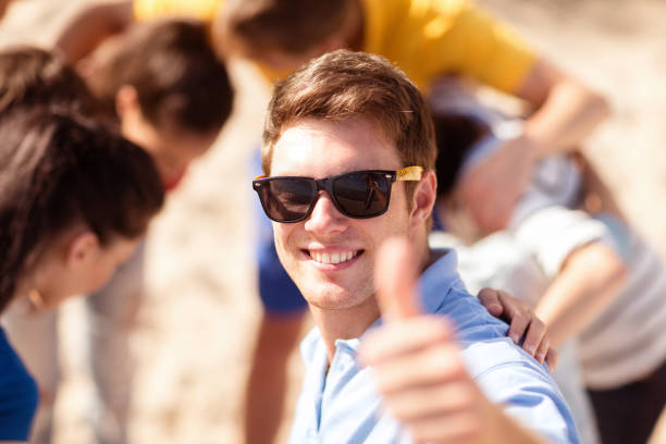 istock happy young man in sunglasses showing thumbs up 1318598507