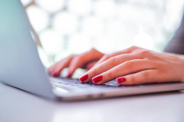 Unrecognizable woman using laptop indoors