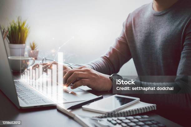Businessman Hand Using And Typing Keyboard Of Laptop Computer Analyzing Sales Data And Economic Growth Plan Graph Chart Success Business Finance And Marketing Digital Technology Concept Stock Photo - Download Image Now