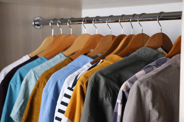 istock Different stylish clothes hanging on rack in wardrobe 1318603252