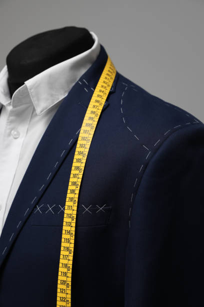 istock Semi-ready jacket with tailor's measuring tape on mannequin, closeup 1318603903