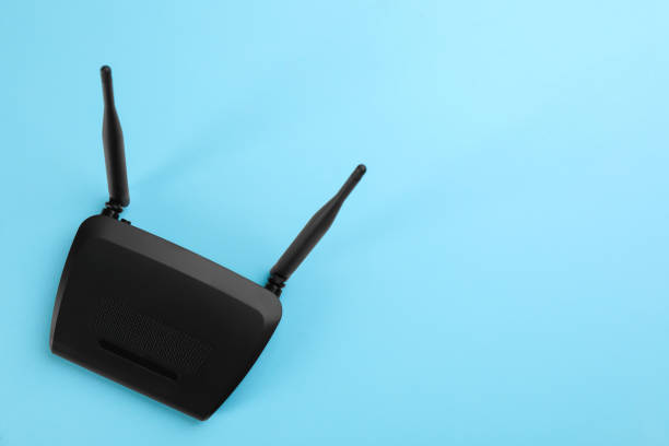 istock Modern Wi-Fi router on light blue background, top view. Space for text 1318604102