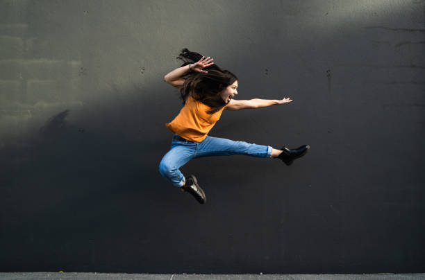 istock Jumping with happiness with black background. 1318604184