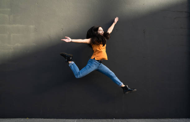 istock Jumping with happiness, arms outreaching and joy. 1318604188