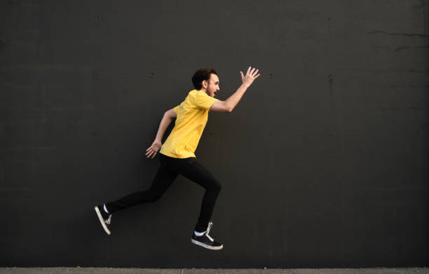 istock Running in excitement with black background. 1318604908