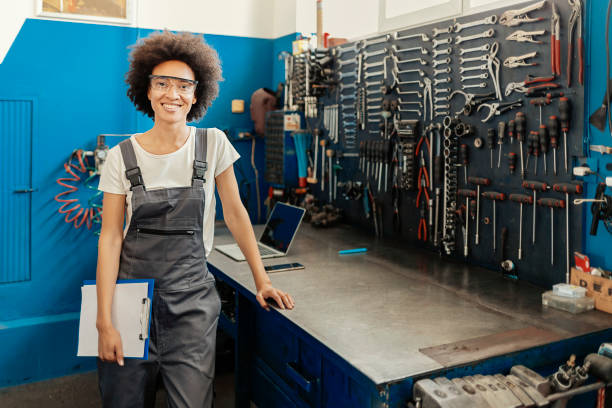 istock Professional Female Mechanic Smiling at Camera 1318605270