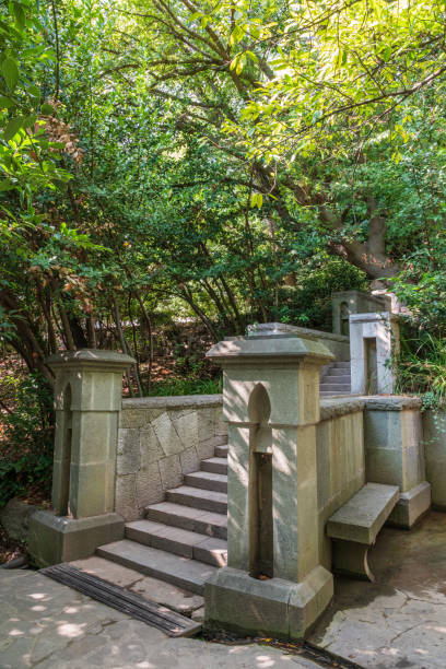 istock Old stone steps in the green park. 1318605508